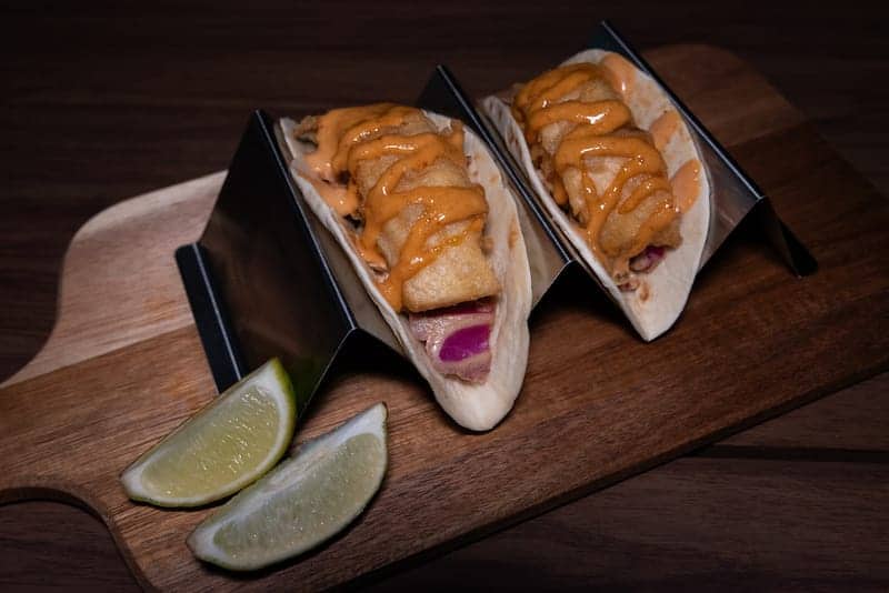 Fried fish tacos with sauce and lime - Picklenpins in NOLA