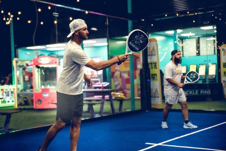 Person pickleball , action shot, in a modern alley at Pickle-Pins