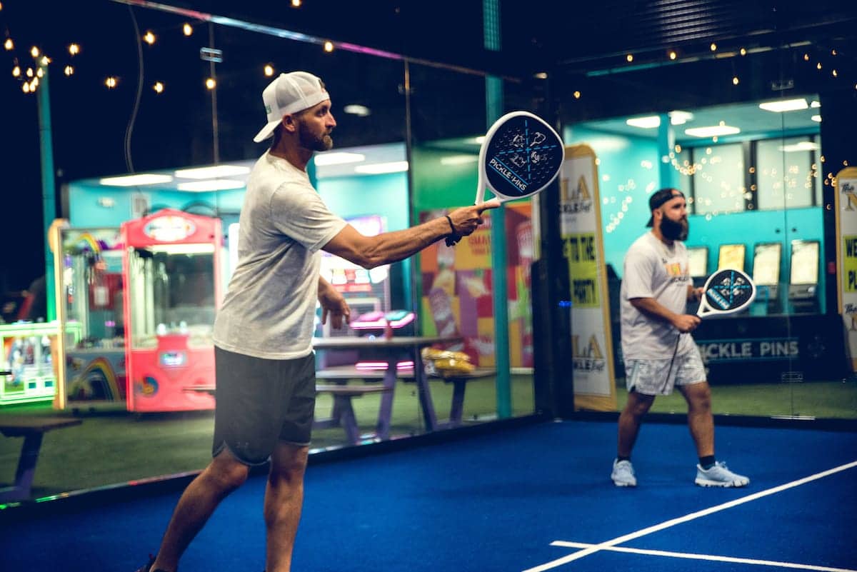 Person pickleball , action shot, in a modern alley at Pickle-Pins
