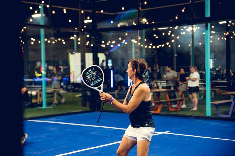 Two women talking and socializing in a pickleball in new game hall - Pickle-Pins
