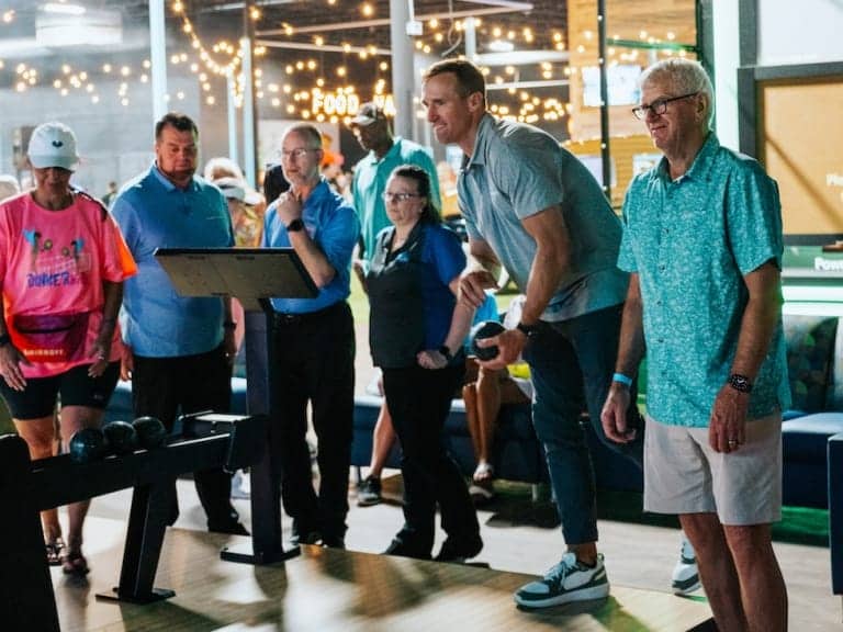 Group of people playing a bowling game together at Pickle-Pins