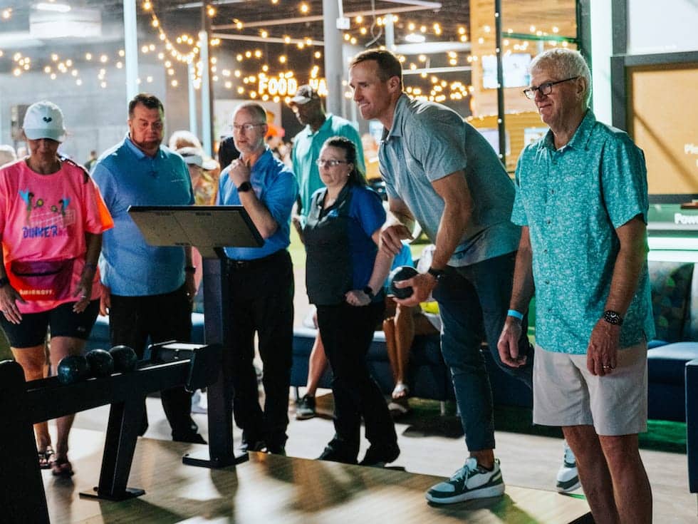 Group of people playing a bowling game together at Pickle-Pins
