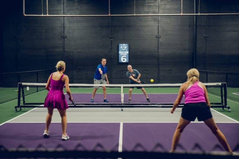 Two people playing pickleball, action shot - Pickle-Pins