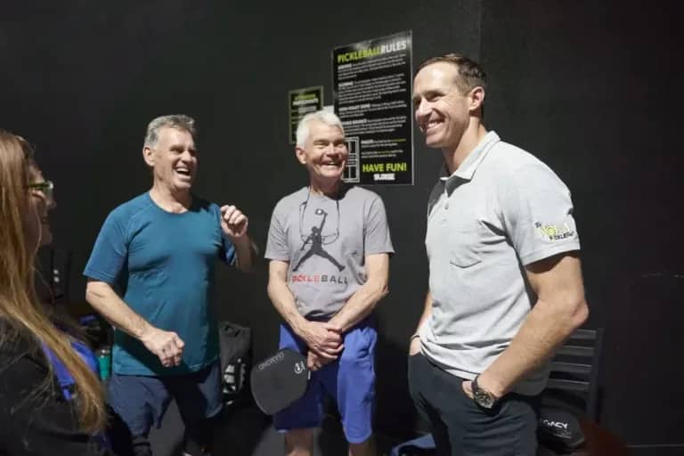Three men standing and smiling indoors pickleball - Pickle-Pins