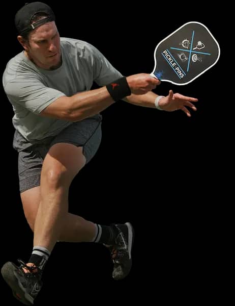 Man playing pickleball, swinging paddle - Pickle-Pins