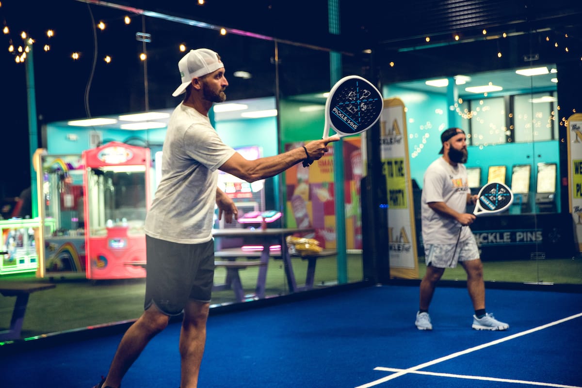 Person pickleball , action shot, in a modern alley at Pickle-Pins Person pickleball , action shot, in a modern alley at Pickle-Pins