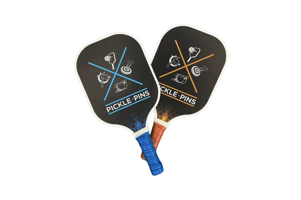 Two Pickle-Pins branded pickleball paddles on a white background